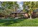 Stunning brick home with a lush green lawn, mature trees, and a charming exterior at 5946 Guilford Ave, Indianapolis, IN 46220