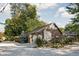 Charming detached garage featuring floral mural artwork and lush landscaping at 5946 Guilford Ave, Indianapolis, IN 46220