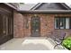 Inviting front entrance with a brick facade, bench, and classic design elements at 5946 Guilford Ave, Indianapolis, IN 46220