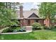 Beautiful Tudor-style home featuring a brick facade, arched doorway, and mature landscaping at 5946 Guilford Ave, Indianapolis, IN 46220