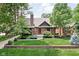 Charming Tudor-style home with lush front lawn and landscaped garden beds at 5946 Guilford Ave, Indianapolis, IN 46220