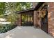 Inviting brick home showcasing a cozy covered front porch with bench seating and charming architectural details at 5946 Guilford Ave, Indianapolis, IN 46220