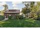 Charming garage featuring lush landscaping, an inviting exterior, and natural light from the many windows at 5946 Guilford Ave, Indianapolis, IN 46220