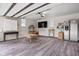 Spacious garage featuring modern flooring, wall-mounted TV, white cabinets, and natural light from the windows at 5946 Guilford Ave, Indianapolis, IN 46220