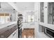 Open kitchen layout with modern appliances, a long island, and seamless flow to the dining area at 5946 Guilford Ave, Indianapolis, IN 46220