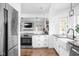 Charming kitchen features stainless steel appliances, hardwood floors, and a beautiful farmhouse sink at 5946 Guilford Ave, Indianapolis, IN 46220