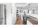 Modern kitchen with stainless steel refrigerator, electric range, hardwood floors and bright lighting at 5946 Guilford Ave, Indianapolis, IN 46220