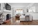 Cozy living room with a stone fireplace, hardwood floors, stained glass door and comfortable seating at 5946 Guilford Ave, Indianapolis, IN 46220