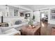Comfortable living room with a plush sofa, leather ottoman, hardwood floors, and barn door at 5946 Guilford Ave, Indianapolis, IN 46220