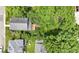 Aerial view of a charming home with a backyard deck, surrounded by lush trees and well-kept lawns at 6107 Broadway St, Indianapolis, IN 46220
