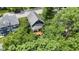 Aerial view of a home with a wooden deck, surrounded by lush greenery and mature trees at 6107 Broadway St, Indianapolis, IN 46220