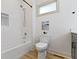 Bright bathroom with a combination tub and shower, plus modern fixtures at 6107 Broadway St, Indianapolis, IN 46220