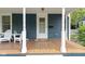 Inviting front porch with a cozy ambiance, white pillars, and classic details, creating an elegant entrance at 6107 Broadway St, Indianapolis, IN 46220