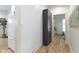Hallway with modern flooring, a built-in pantry, and access to the bedroom and kitchen at 6107 Broadway St, Indianapolis, IN 46220