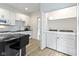 Eat-in kitchen with granite counters, stainless appliances, and adjacent laundry area at 6107 Broadway St, Indianapolis, IN 46220