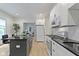 Updated kitchen boasts stainless steel appliances, gray kitchen island, and ample cabinet space at 6107 Broadway St, Indianapolis, IN 46220