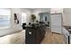 Bright kitchen featuring a black island with seating, modern appliances, and stylish decor at 6107 Broadway St, Indianapolis, IN 46220