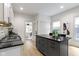 Bright kitchen features gray island with black countertops, white cabinetry, and stainless steel appliances at 6107 Broadway St, Indianapolis, IN 46220