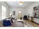 Comfortable living room featuring a gray sectional, stylish decor, and a light-filled atmosphere at 6107 Broadway St, Indianapolis, IN 46220