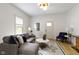 Stylish living room with a gray sectional, modern rug, and ample natural light at 6107 Broadway St, Indianapolis, IN 46220