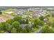 Aerial view of homes in a neighborhood with mature trees and pond at 6575 E 171St St, Noblesville, IN 46062