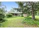 Back exterior of the house surrounded by lush greenery and mature trees at 6575 E 171St St, Noblesville, IN 46062