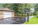 View of the home's private basketball court, garage, landscaping and backyard at 6575 E 171St St, Noblesville, IN 46062