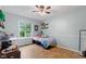 Cozy bedroom with hardwood floors, a ceiling fan, and a sun-filled window view at 6575 E 171St St, Noblesville, IN 46062
