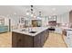 Spacious kitchen featuring a center island, stainless steel appliances, and a sliding barn door at 6575 E 171St St, Noblesville, IN 46062