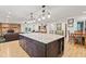 Open concept kitchen featuring a large island, modern lighting, and stainless steel appliances at 6575 E 171St St, Noblesville, IN 46062