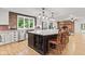 Bright, open kitchen featuring a large island with seating, stainless appliances, and modern lighting at 6575 E 171St St, Noblesville, IN 46062