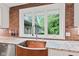 Stylish copper sink beneath a window with granite countertops and stainless steel dishwasher at 6575 E 171St St, Noblesville, IN 46062