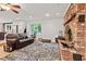 Cozy living room with a brick fireplace, hardwood floors, and a comfortable seating area at 6575 E 171St St, Noblesville, IN 46062