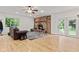 Bright living room featuring a brick fireplace, wood floors, and access to the backyard at 6575 E 171St St, Noblesville, IN 46062