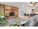 Comfortable living room with a brick fireplace, wood mantel, and a ceiling fan at 6575 E 171St St, Noblesville, IN 46062