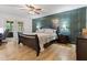 Elegant main bedroom with wood paneling, a ceiling fan, and French doors leading to the outdoors at 6575 E 171St St, Noblesville, IN 46062