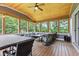 Relaxing screened porch with wood flooring, ample seating, and serene outdoor views at 6575 E 171St St, Noblesville, IN 46062