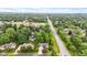 Aerial view of a neighborhood with mature trees and a clear view of a home with an attached garage at 6980 White Oak Dr, Avon, IN 46123