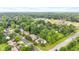An aerial view of a residential area with mature trees and a home with a two-car garage and landscaping at 6980 White Oak Dr, Avon, IN 46123
