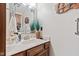 Bathroom features a marble countertop, dark wood cabinets, and decorative wall art for a unique design at 6980 White Oak Dr, Avon, IN 46123
