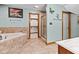 Serene bathroom with a standalone tub, glass shower, walk-in closet, and butterfly wall art for a tranquil experience at 6980 White Oak Dr, Avon, IN 46123