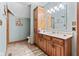 Well-lit bathroom with oak cabinetry, a vanity sink, and a calming blue color scheme, for a spa-like feel at 6980 White Oak Dr, Avon, IN 46123