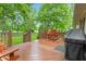 Expansive deck featuring outdoor seating, a grill, and beautiful views of the lush backyard at 6980 White Oak Dr, Avon, IN 46123
