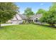 Lush front lawn frames this charming brick home with attached garage and mature trees at 6980 White Oak Dr, Avon, IN 46123