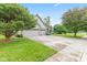 Brick home with a well-maintained lawn, mature trees, and a spacious driveway leading to the garage at 6980 White Oak Dr, Avon, IN 46123