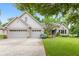 Charming brick home with a well-manicured lawn, mature trees, and a spacious three-car garage at 6980 White Oak Dr, Avon, IN 46123