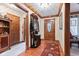 Inviting foyer with hardwood floors, decorative mirror and striking front door at 6980 White Oak Dr, Avon, IN 46123