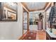 Open foyer with hardwood flooring transitioning into carpeted areas, leading to the living spaces at 6980 White Oak Dr, Avon, IN 46123