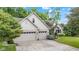 Charming home featuring an attached two-car garage and a manicured front yard with mature trees at 6980 White Oak Dr, Avon, IN 46123