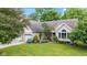 Well-maintained single-Gathering home with lush landscaping, a brick facade, and a welcoming front porch at 6980 White Oak Dr, Avon, IN 46123